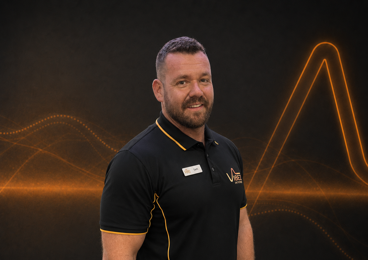 A smiling trainer wearing a polo shirt | VibeZ 24/7 Fitness